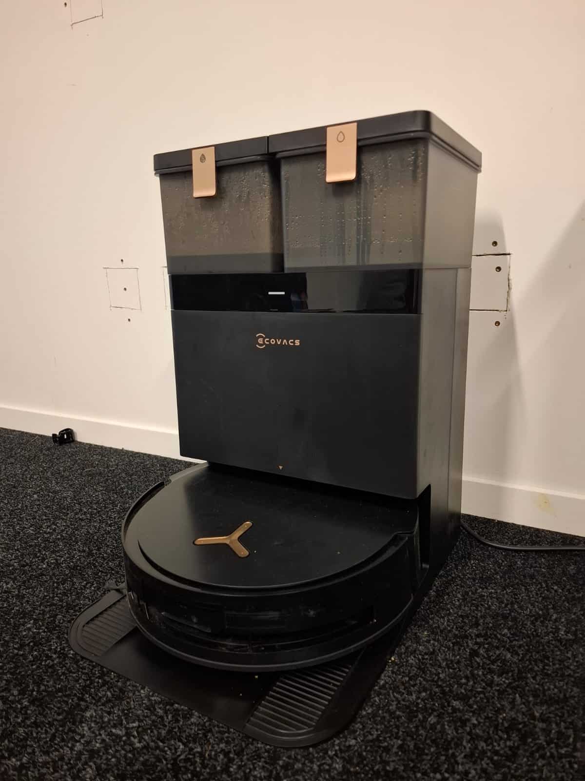 Robot vacuum cleaner with self-emptying docking station on carpet in a modern home